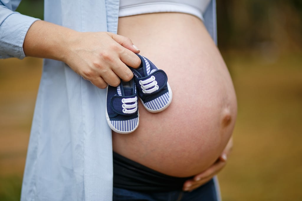PREGNANT HOLDING BABY SHOES