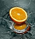 sliced orange drop in water